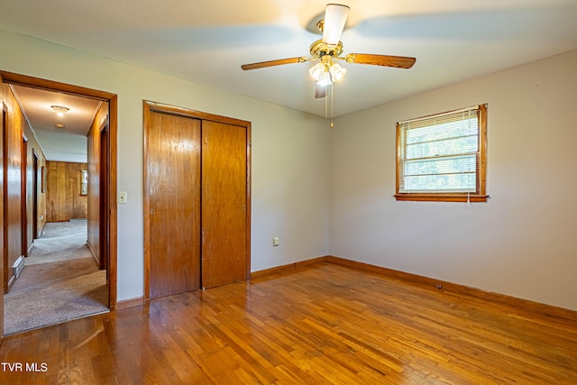 unfurnished bedroom with carpet flooring, ceiling fan, and a closet