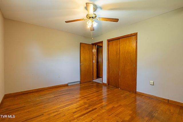 unfurnished bedroom with ceiling fan, hardwood / wood-style flooring, and a baseboard radiator