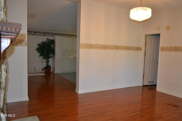 unfurnished room featuring ornamental molding and dark hardwood / wood-style flooring