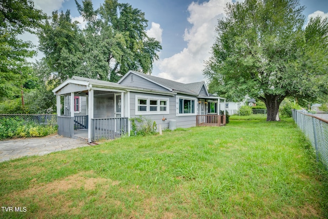 rear view of property featuring a yard