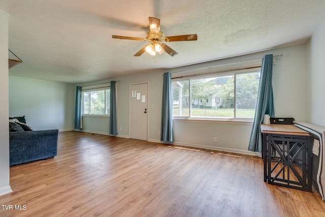 foyer with ceiling fan, light wood-type flooring, and a textured ceiling