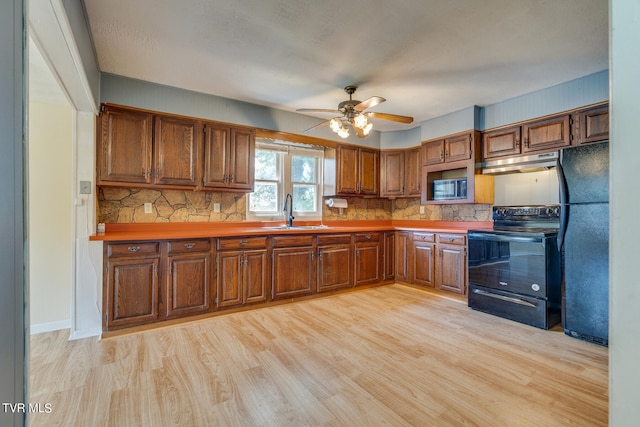 kitchen with ceiling fan, backsplash, light hardwood / wood-style floors, sink, and black appliances