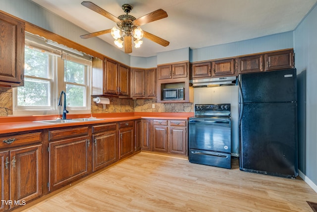 kitchen with ceiling fan, decorative backsplash, light hardwood / wood-style flooring, sink, and black appliances