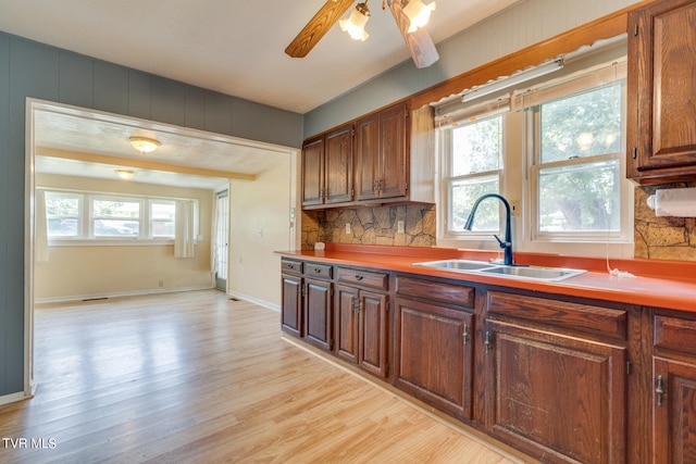 kitchen with light hardwood / wood-style floors, sink, plenty of natural light, and ceiling fan