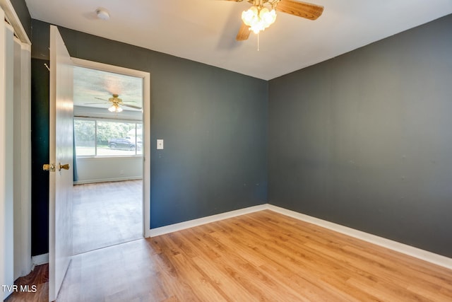 empty room featuring ceiling fan and hardwood / wood-style floors