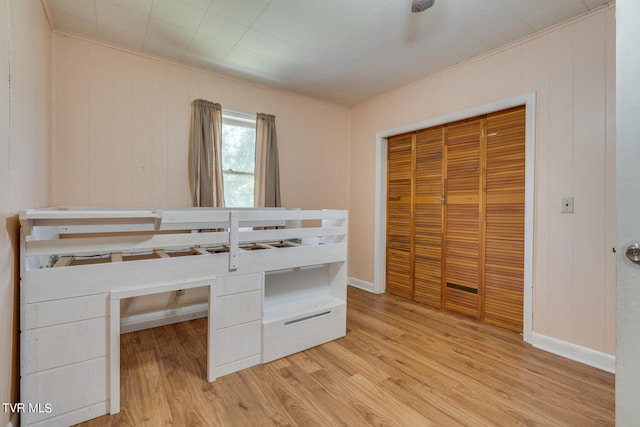 unfurnished bedroom with a closet and light hardwood / wood-style flooring