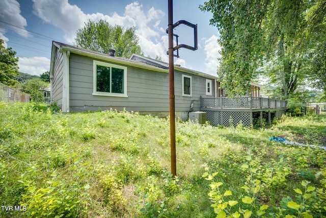 back of house featuring central AC and a deck