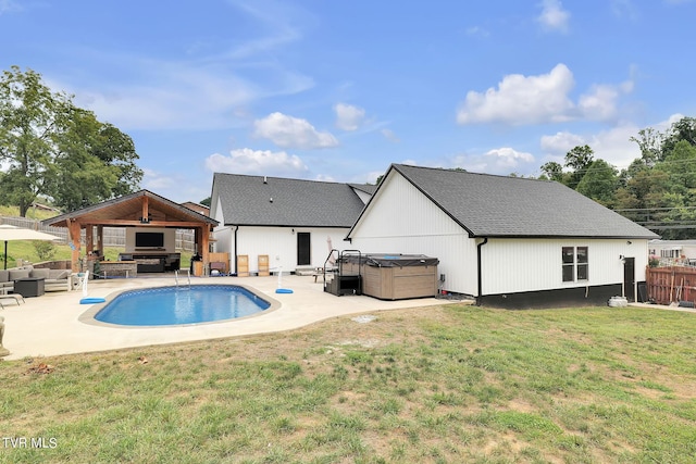 exterior space featuring fence, an outdoor living space, a gazebo, a lawn, and a hot tub