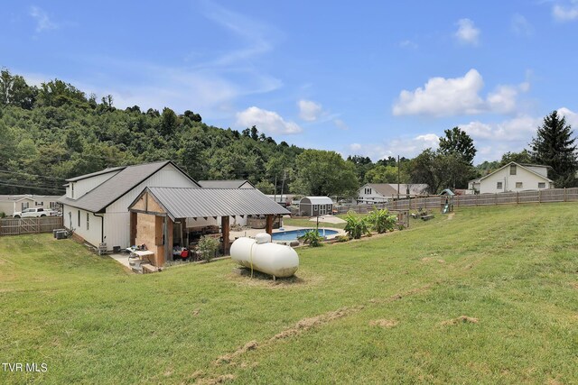 view of yard with a fenced in pool and fence