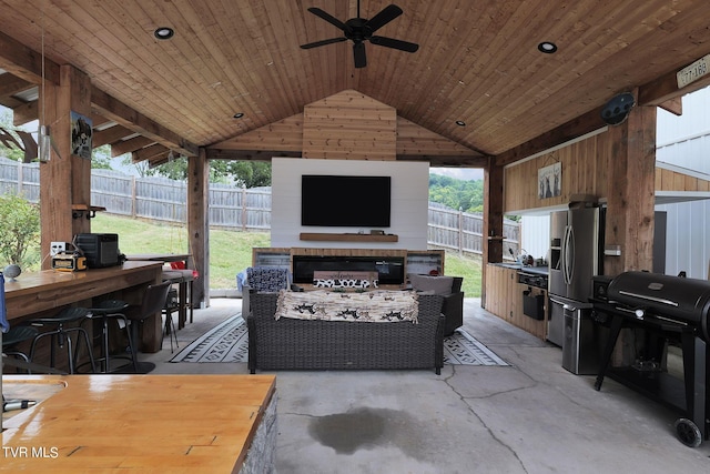 view of patio / terrace with a gazebo, area for grilling, ceiling fan, a bar, and a fenced backyard