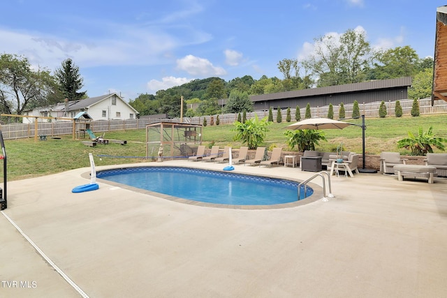 view of pool with a playground, a fenced backyard, a lawn, a fenced in pool, and a patio area