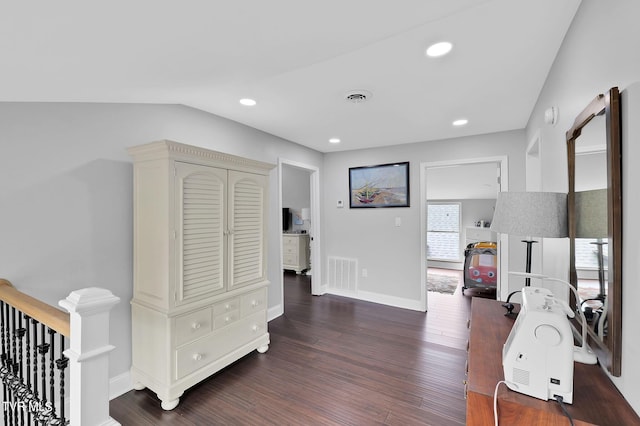 hallway featuring dark wood-style floors, recessed lighting, visible vents, and baseboards