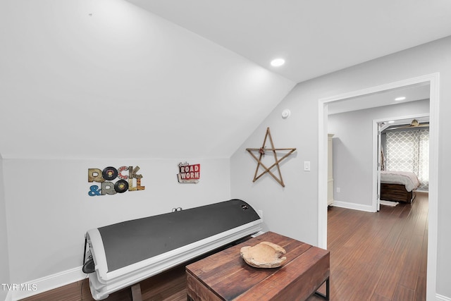 interior space with dark wood-style floors, recessed lighting, lofted ceiling, and baseboards