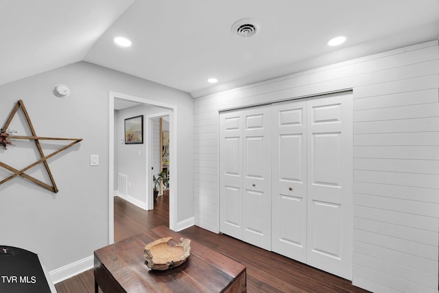 interior space featuring dark wood-style floors, recessed lighting, lofted ceiling, visible vents, and baseboards