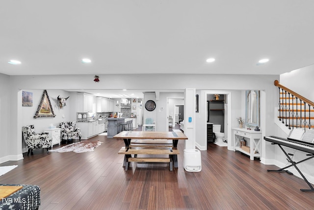 workout area featuring dark wood-type flooring, recessed lighting, and baseboards