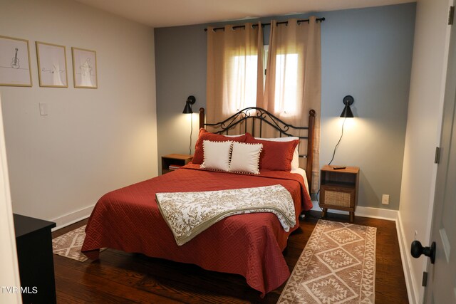 bedroom with dark wood-type flooring