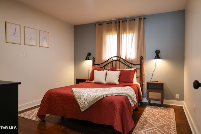 bedroom with dark wood-type flooring