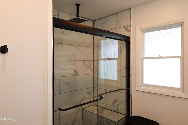 interior space featuring a shower with door