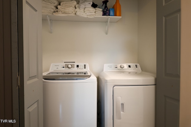 clothes washing area with washer and clothes dryer