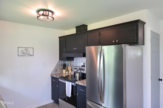 kitchen featuring custom range hood, appliances with stainless steel finishes, decorative backsplash, light stone counters, and light hardwood / wood-style floors