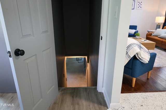 corridor with hardwood / wood-style floors