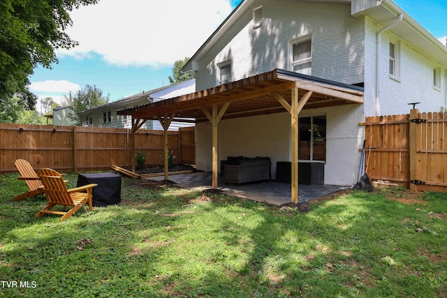 rear view of property with a pergola, a yard, and a patio