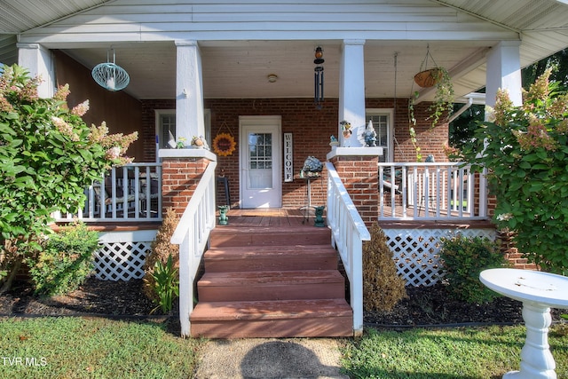 view of exterior entry featuring a porch