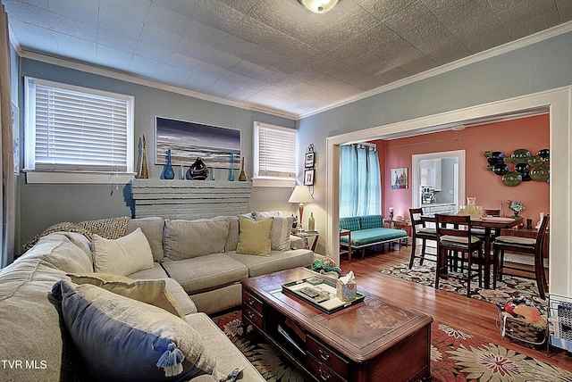 living room with hardwood / wood-style flooring and ornamental molding