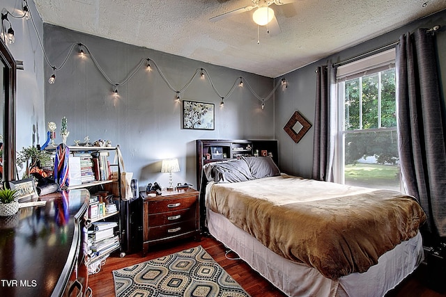 bedroom featuring ceiling fan, wood-type flooring, and a textured ceiling