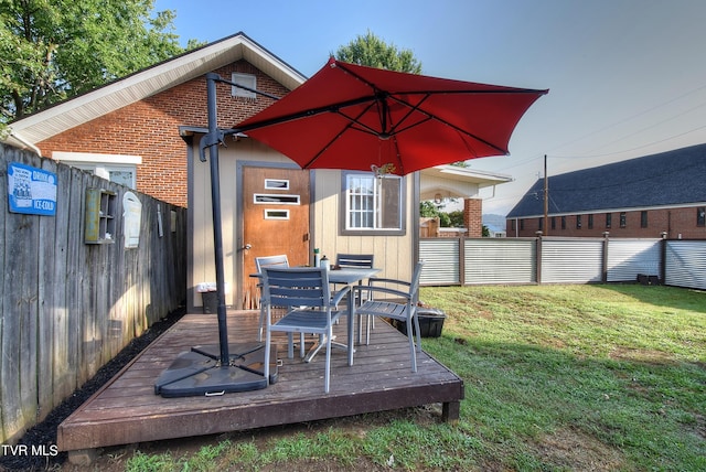 wooden deck with a lawn