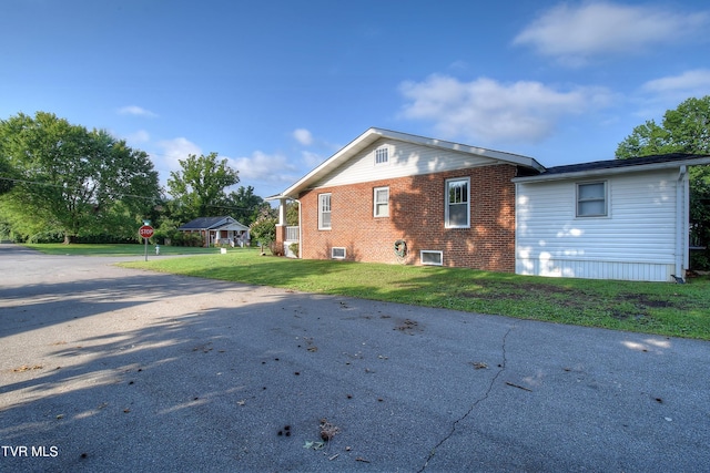 rear view of property with a yard