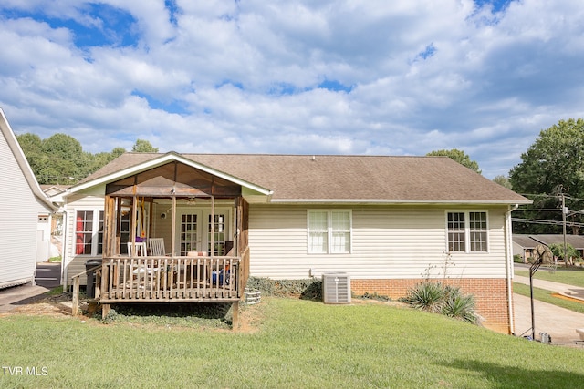 view of front of home with a front lawn and cooling unit