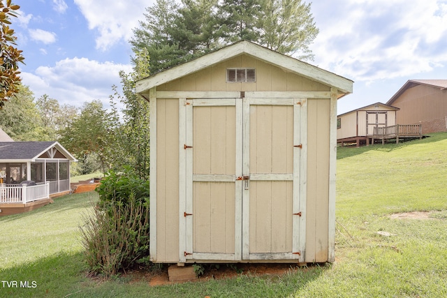 view of outbuilding featuring a yard