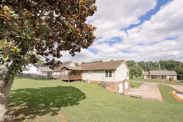 rear view of property with a lawn and a wooden deck