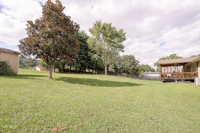 view of yard featuring a deck and cooling unit