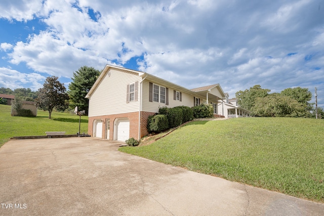 view of side of home featuring a lawn and a garage