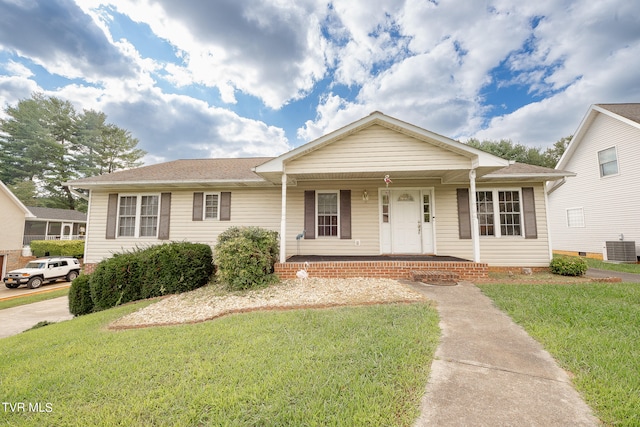 view of front of property with covered porch, cooling unit, and a front lawn