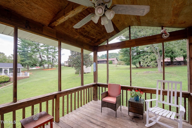 sunroom featuring ceiling fan, plenty of natural light, vaulted ceiling with beams, and wood ceiling