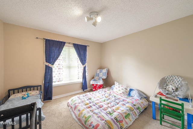 bedroom featuring a textured ceiling and light carpet