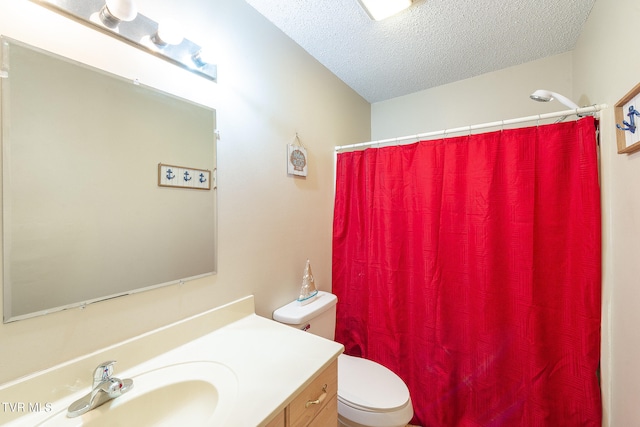 bathroom with a textured ceiling, toilet, and vanity