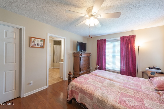 bedroom featuring ceiling fan, hardwood / wood-style flooring, and a textured ceiling