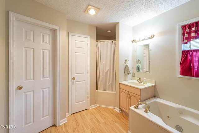 bathroom featuring a textured ceiling, vanity, and hardwood / wood-style floors