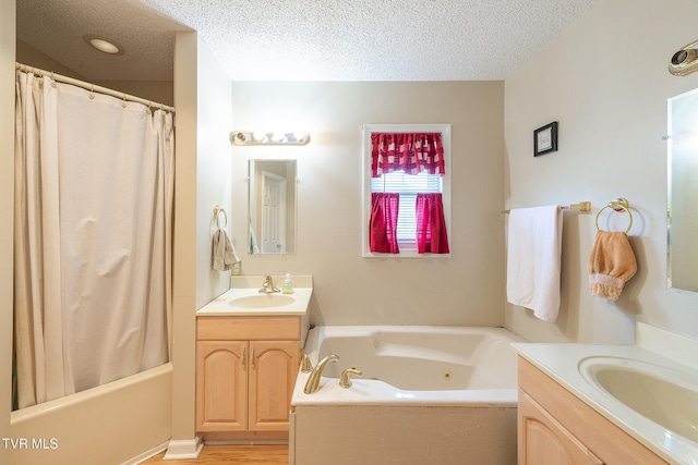 bathroom with hardwood / wood-style flooring, a textured ceiling, and vanity