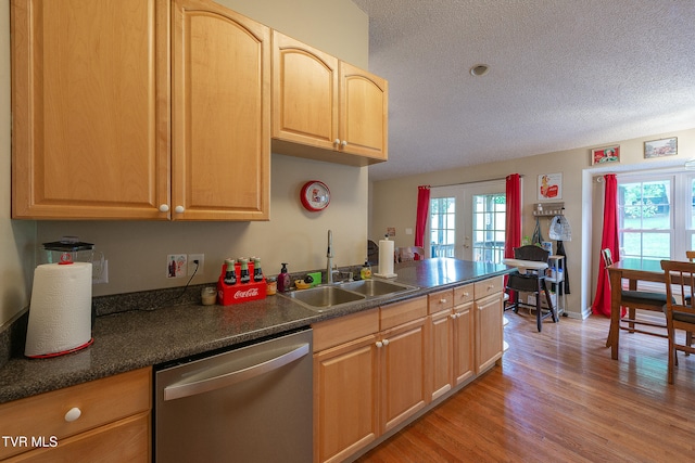 kitchen featuring dishwasher, light hardwood / wood-style floors, french doors, sink, and a textured ceiling