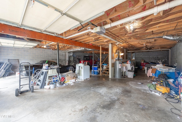 garage with gas water heater and a garage door opener