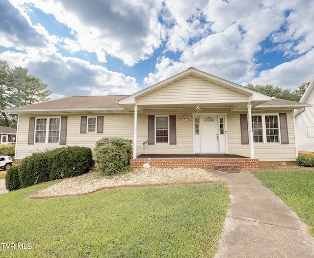 single story home with covered porch and a front lawn