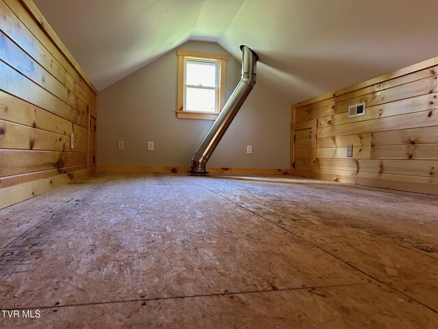 bonus room featuring wood walls and lofted ceiling