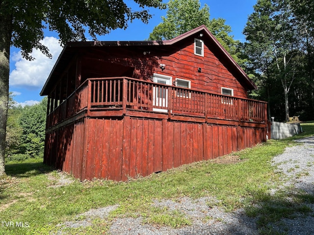 view of property exterior with a wooden deck