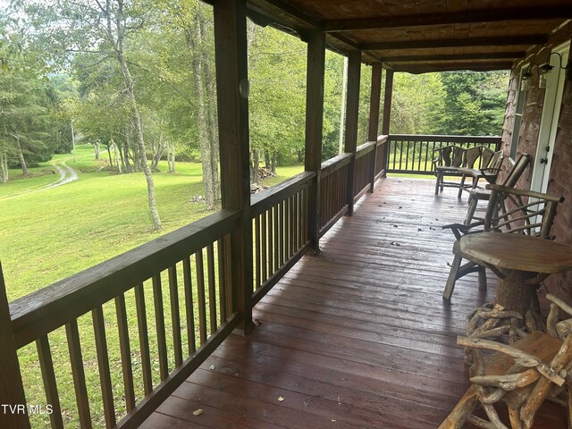 wooden deck with a lawn