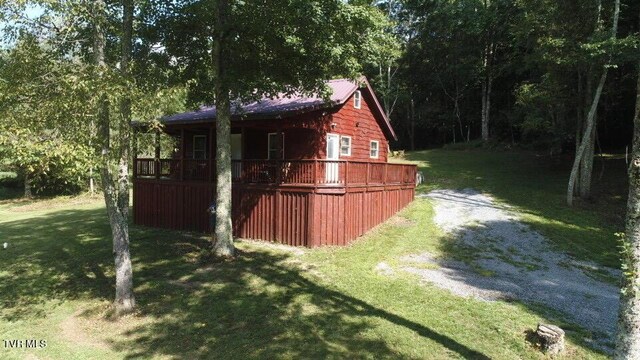 view of outdoor structure featuring a lawn